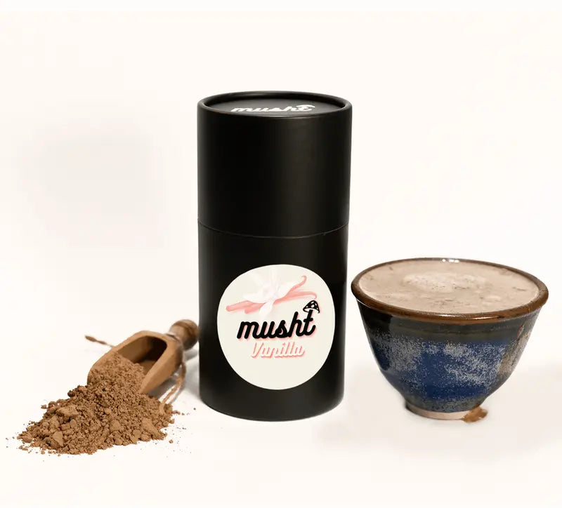 Musht Vanilla pack beside a prepared drink